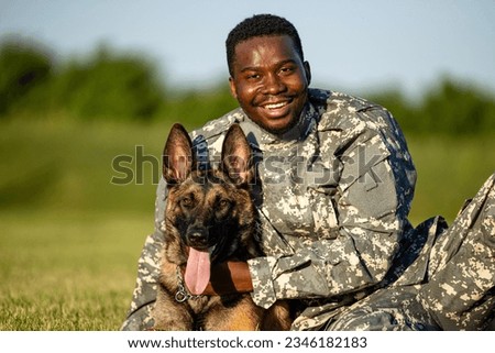 Portrait of soldier in uniform embracing his military dog. Royalty-Free Stock Photo #2346182183