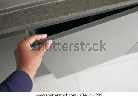 man's hand open drawer wooden in cabinet Royalty-Free Stock Photo #2346206289