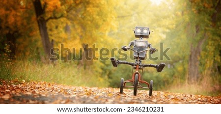 Happy humanoid robot rides a bicycle along the autumn alley. Robotic object experiences feelings and emotions. Concept of technology development in the form of artificial intelligence. Royalty-Free Stock Photo #2346210231
