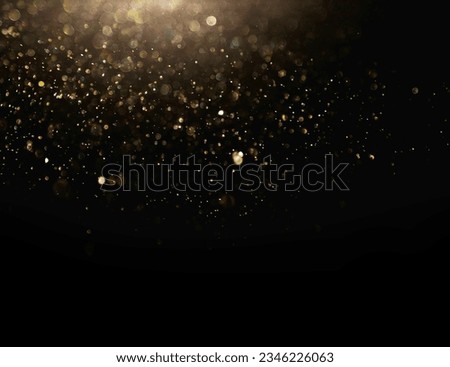 Glowing Particles Stock Image In Black Background, Festive abstract Christmas texture, golden bokeh particles and highlights on dark background. High quality photo