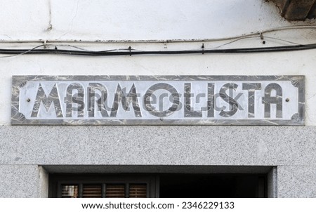 Store and workshop of a marble worker labeled in Spanish language. Workplace signboard of a marble worker (marmolista) engraved on the marble lintel.