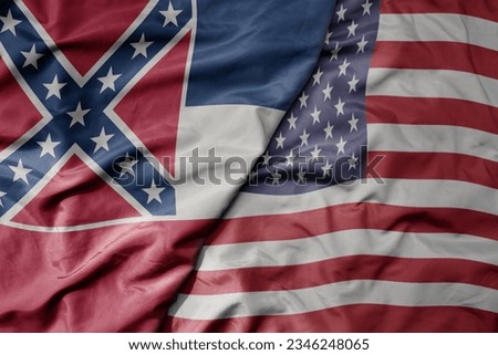 big waving colorful national flag of united states of america and flag of mississippi state . macro