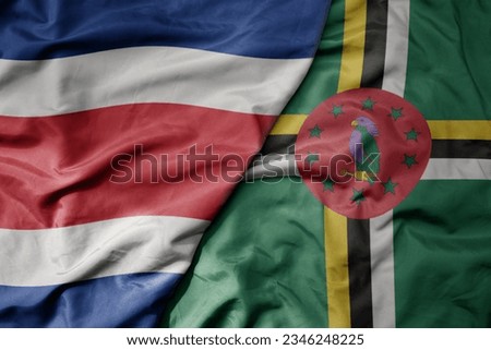 big waving realistic national colorful flag of chile and national flag of dominica . macro