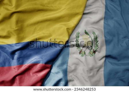 big waving realistic national colorful flag of colombia and national flag of guatemala . macro