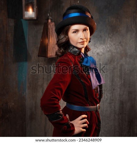 A stylish lady in a burgundy old - fashioned suit with a hat . Brunette in a retro style suit Royalty-Free Stock Photo #2346248909