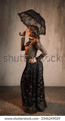 A stylish lady in an elegant suit in the Victorian style, a suit in the style of Mary Poppins, a kind teacher Royalty-Free Stock Photo #2346249029