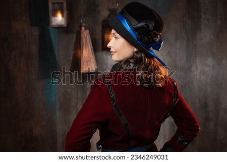 A stylish lady in a burgundy old - fashioned suit with a hat . Brunette in a retro style suit Royalty-Free Stock Photo #2346249031