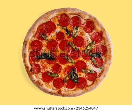 appetizing pepperoni pizza with jalapeno on yellow background, studio shot