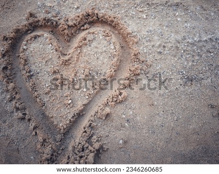 a picture of a heart painted on the sand