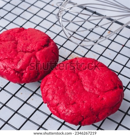 Freshly baked Chunky red velvet Cookies on cooling rack, nutella, milk on white background