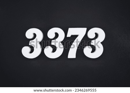 Black for the background. The number 3373 is made of white painted wood.