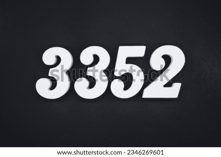 Black for the background. The number 3352 is made of white painted wood.