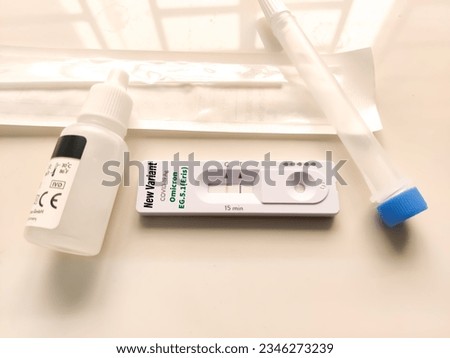 Positive Covid-19, SARS‑CoV‑2 Omicron EG.5.1(Eris) antigen test kit for self testing, one step coronavirus antigen rapid test, saliva swab, 1 test box, close up Royalty-Free Stock Photo #2346273239