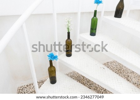 Metal spiral staircase in minimalistic white and vase flower,vase with white and blue beautiful flowers,Soft home decor,Space for text.