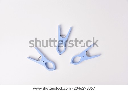 isolated, Blue plastic clothspin or laundry clip on white background.