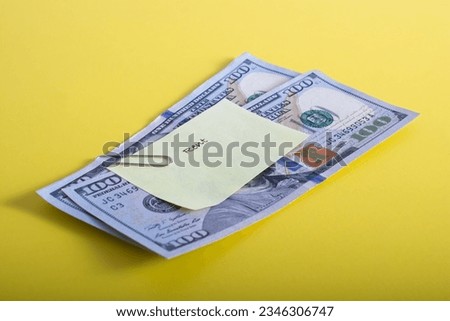 Reminder slip labeled ‘Rent’ posted to two one hundred dollar bills