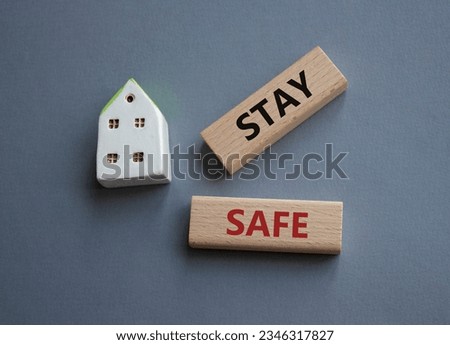 Stay Safe symbol. Concept word Stay Safe on wooden blocks. Beautiful grey background. Business and Stay Safe concept. Copy space. Concept word