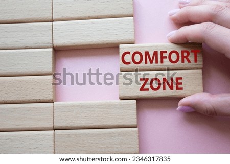 Comfort zone symbol. Concept word Comfort zone on wooden blocks. Businessman hand. Beautiful pink background. Business and Comfort zone concept. Copy space. Concept word Royalty-Free Stock Photo #2346317835