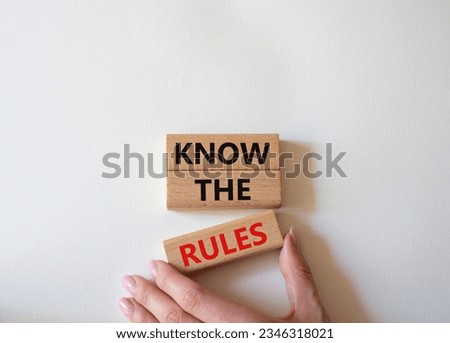 Know the rules symbol. Wooden blocks with words Know the rules. Beautiful white background. Businessman hand. Business and Know the rules concept. Copy space. Concept word