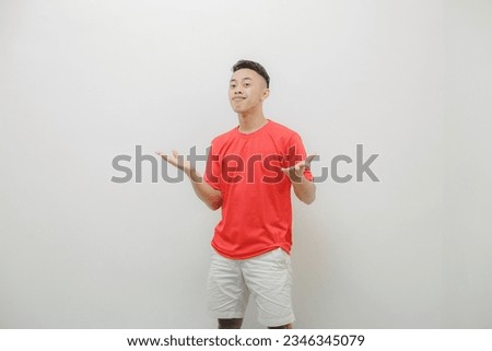 a young man wearing a red shirt on a white background with a cheerful expression
