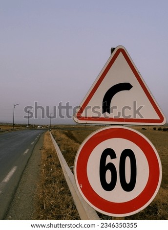 A picture of traffic signs in the side of the road (careful a turn, it is algellt to go over 60kmh)