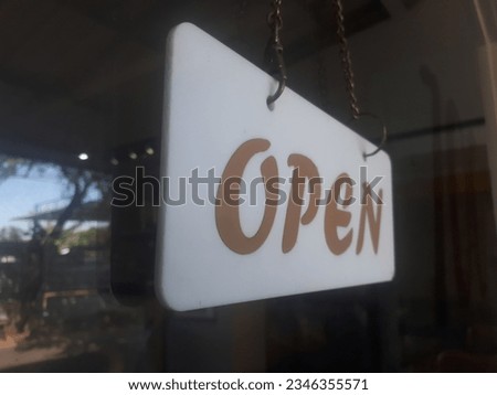 open and close sign hung on a glass
