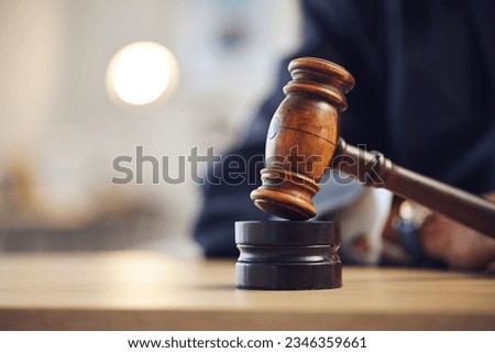 Law, judge and closeup of lawyer with gavel for justice, court hearing and legal trial for magistrate. Government, attorney career and zoom of desk for investigation, criminal case and verdict order Royalty-Free Stock Photo #2346359661