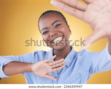 Hands, frame and portrait of black woman in studio smile for confidence, creativity or beauty. Photography, perspective and face of African person on yellow background in cosmetics, makeup or glamour