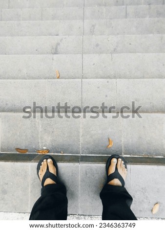 High Angle View of a Black Sandals on White Ground with copyspace
