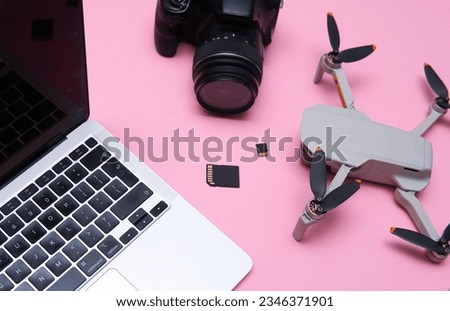 top view of freelance photographer work tools. Flat lay photo showing laptop, camera, drone and memory cards