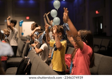 Group of little kids playing games, dancing in circle and having fun in camp Royalty-Free Stock Photo #2346374939