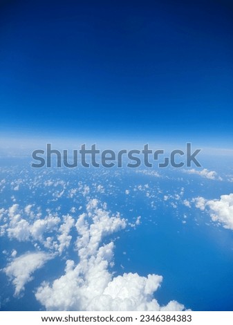 Clear blue sky with clouds pictured from plane