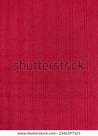 a red fabric with square grid pattern