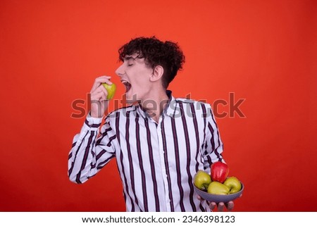 Different emotions. Funny guy posing on an orange background with different products.