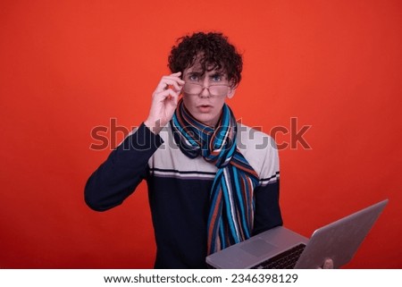 Different emotions. Funny guy posing on an orange background and playing games.