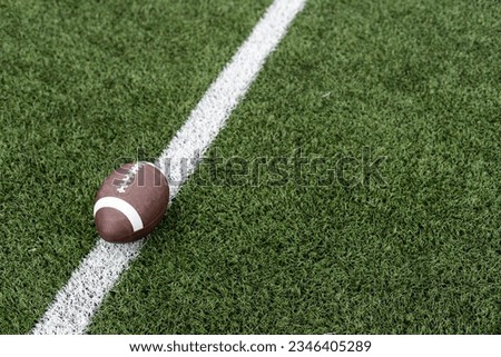 rugby ball on rugby pitch grass with copy space Royalty-Free Stock Photo #2346405289