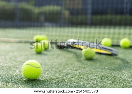 Leeds UK May 24 2016 Tennis ball and racket on a hard court with coloured filter applied during processing-illustrative editorial Royalty-Free Stock Photo #2346405373
