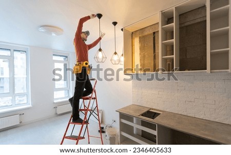 working man is working on repairs Royalty-Free Stock Photo #2346405633