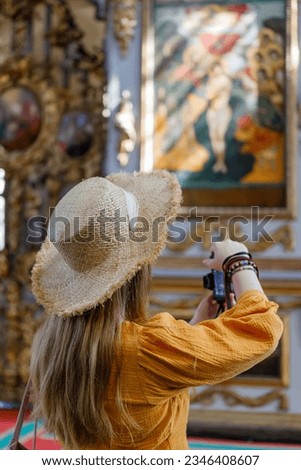 Tourist female taking picture smart phone. Tourist back woman doing a photo in church