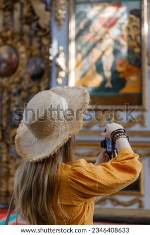Tourist female taking picture smart phone. Tourist back woman doing a photo in church