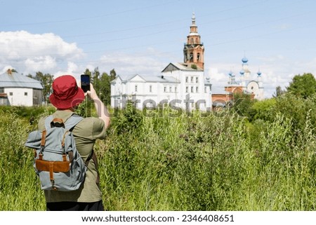 Tourist takes picture of Orthodox Church. Concept of sightseeing and tourism in Russia.