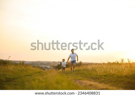 father's day. Dad and son playing together outdoors on a summer. Happy family, father, son at sunset