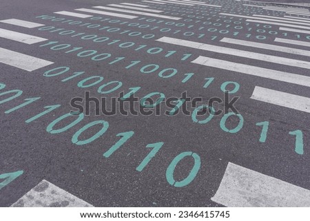 binary code painted on pedestrian crossing. technology development concept.
