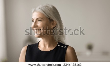 Happy beautiful blonde mature woman banner casual portrait. Cheerful senior lade posing indoors, looking away, thinking on good retirement plans with toothy smile, laughing Royalty-Free Stock Photo #2346428163