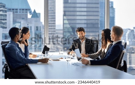 Happy international multiethnic professional business team, diverse executive colleagues people discussing financial project working together in office at group meeting table in corporate board room. Royalty-Free Stock Photo #2346440419