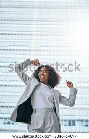 Happy excited confident professional young African American business woman office leader executive wearing suit celebrating success standing in big city street feeling strong and powerful concept. Royalty-Free Stock Photo #2346454897