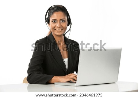 Portrait of a happy young Indian female call centre employee with a headset. Isolated on a white background. Royalty-Free Stock Photo #2346461975