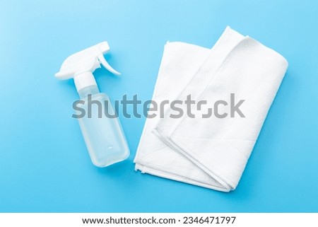Spray and rag on blue background. Royalty-Free Stock Photo #2346471797