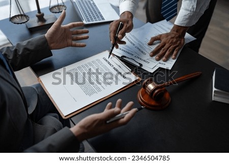 Attorneys or lawyer reading statute of limitations, consulting between male lawyers and business clients, tax firms and examining contract documents in business before signing