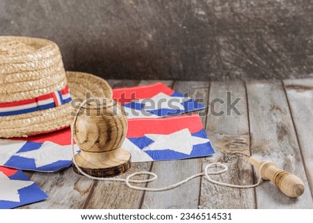 Fiestas Patrias Chile September 18th, Independence Day. Huaso hat, straw hat and creole emboque, on wooden table with flag, copy space. Chilenidad Royalty-Free Stock Photo #2346514531